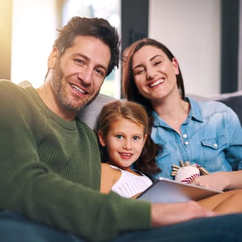 Were always happy spending time together. a young family using a tablet and chilling on the sofa together at home