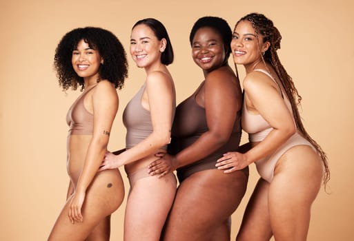 Diversity women, body shape and portrait of group together for inclusion, natural beauty and power. Underwear model friends happy on beige background with cellulite, pride and self love motivation.