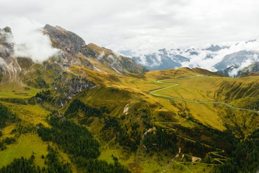 The mystical beauty of the Dolomite Alps as a blanket of clouds drapes over the valley, creating an ethereal atmosphere in the famous Giau Pass.
