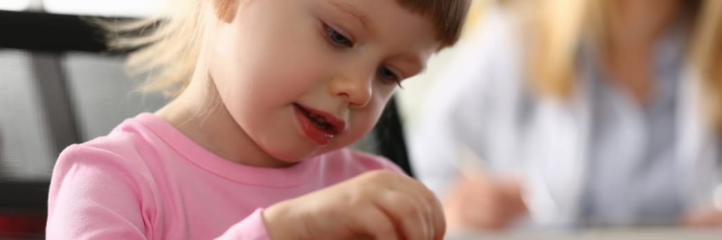 Portrait of beautiful little girl in background is doctor. Pediatric services and children health insurance