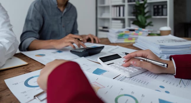 Team Of Business working at office with documents on his desk, doing planning analyzing the use a financial calculator, business plan investment, finance analysis concept.