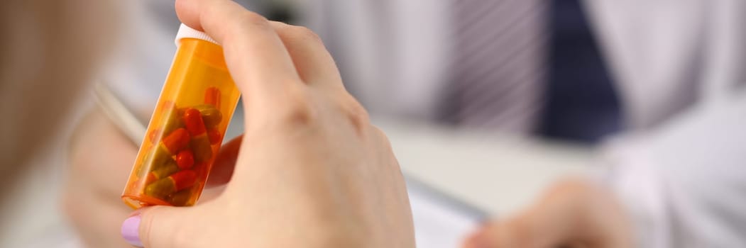 Closeup of patient hands with medical pills and doctor. Medical drugs and treatment of diseases concept