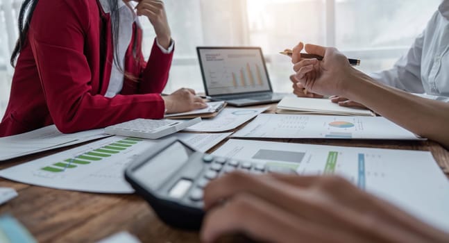 Team Of Business working at office with documents on his desk, doing planning analyzing the use a financial calculator, business plan investment, finance analysis concept.