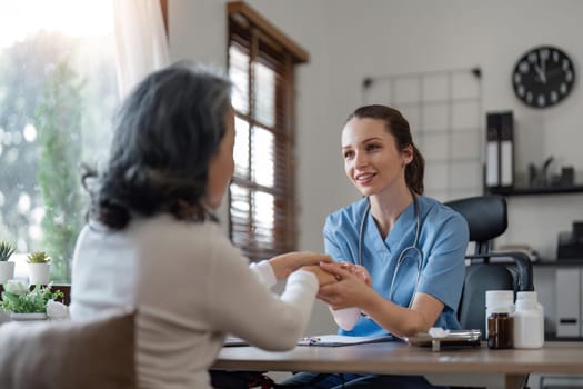 Senior care, healthcare insurance and caregiver woman sitting with elderly woman patient laughing and talking while enjoying retirement home. Old lady and female nurse hospice with health check form.