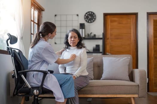 female caregiver visit senior grandmother check heart rate, young woman doctor use statoscope do regular checkup of old lady patient at home, elderly healthcare concept.