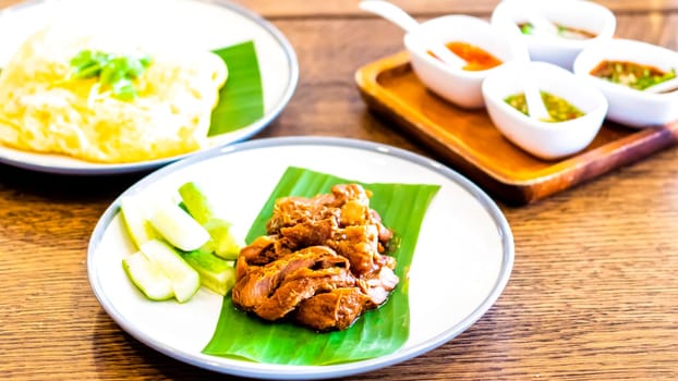 Thai food Fried Pork on banana leaf with Garlic Rice and vegetable