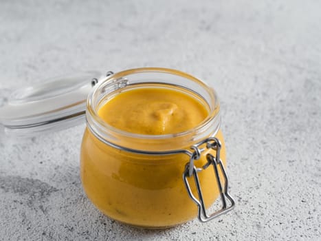 Creamy Cheddar sauce with chia seeds on gray background.Ideas and recipe for healthy diet or vegan food.Homemade Chia Cheeze Sauce for snacks,tacos,nachos,dipping,mac-n-cheese,base for pizza.Copyspace