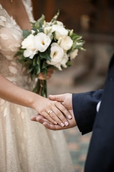 Newlyweds on wedding day, wedding couple holding hands, bride and groom