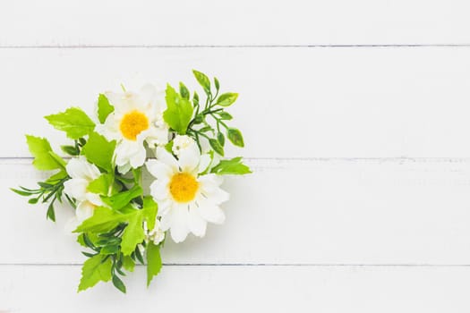 Top view of a fake bunch of flowers on white table background for nature decoration and springtime concept