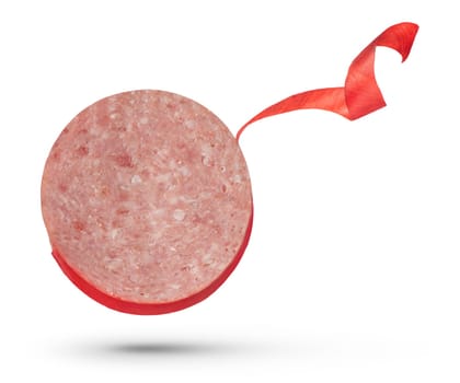 A slice of salami sausage on a white isolated background. The process of removing the red protective film from the surface of the sausage. To be inserted into a design or project