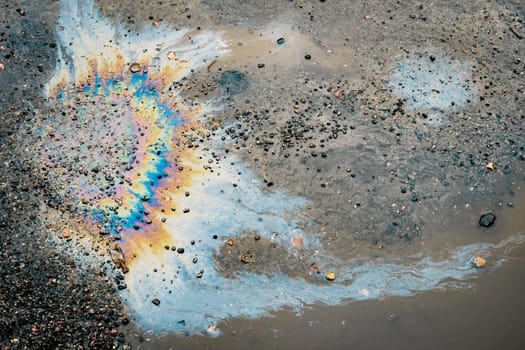 Oil petrol water pollution. Abstract background of motor oil, gas or gasoline spilled on the road