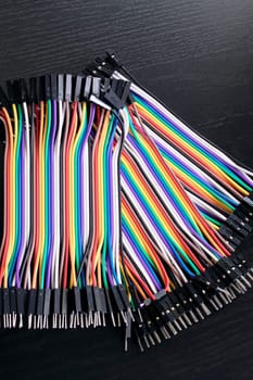 Multicolored computer wires on a black background, macro photo