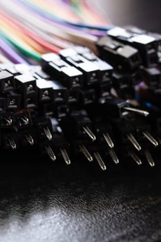 Multicolored computer wires on a black background, macro photo