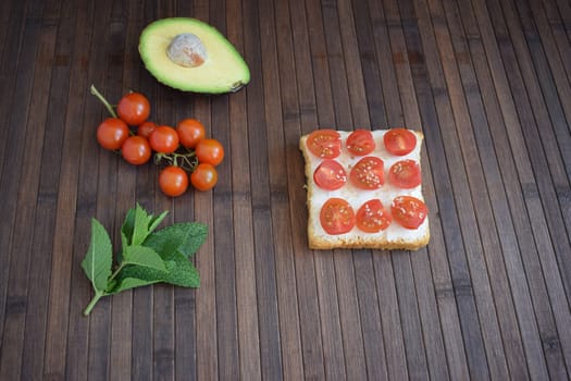 Healthy breakfast toast with tomatoes, ricotta and herbs.