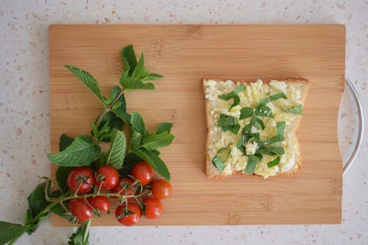 Healthy toast for breakfast with avocado, eggs, tomatoes, arugula etc.