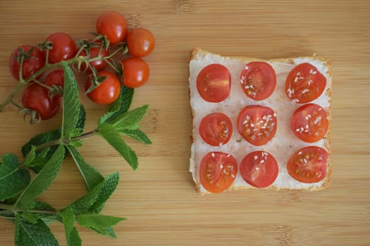 Healthy toast for breakfast with avocado, eggs, tomatoes, arugula etc.