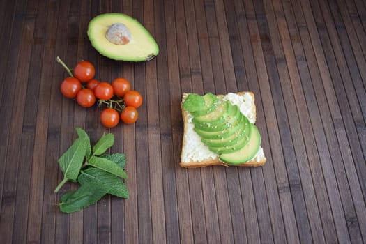 Healthy breakfast toast with avocado, ricotta and herbs.