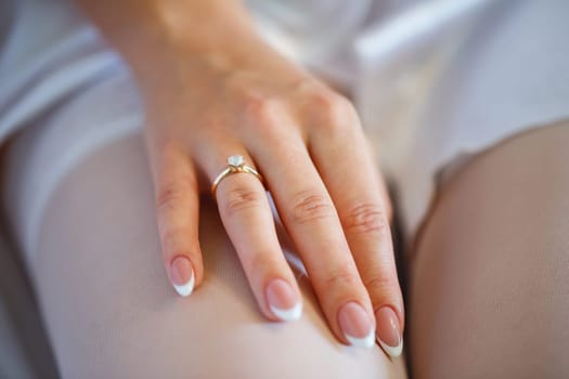 gold wedding rings in hands of newlyweds on wedding day