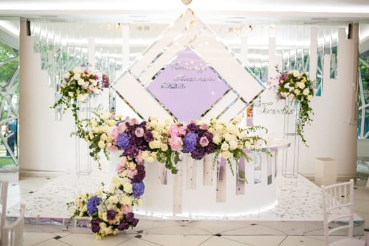 Wedding decor made of flowers and fabric. Beautiful decorations for newlyweds on their wedding day