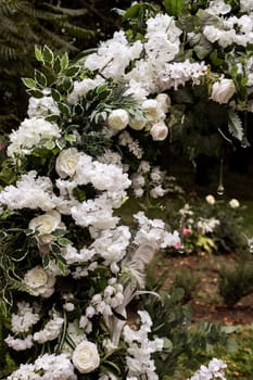 Festive arch for the ceremony of painting the newlyweds on the wedding day, wedding decor with fresh flowers