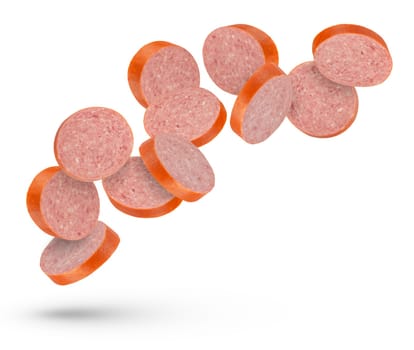 Flying sausage. Slices of smoked sausage on a white isolated background. Salami slices fall on a white background, for insertion into a design or project. High quality photo