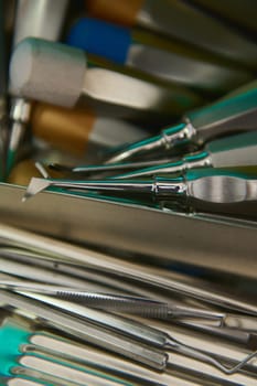 Selective focus. Closeup professional stainless steel dental instruments and accessories inside an ultraviolet sterilizing machine, autoclave, UV sterilizer. Medical instruments sterilized under UV