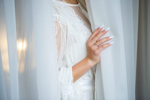 Beautiful bride in a white coat on a wedding day