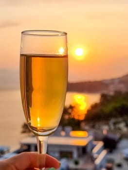 Caucasian woman hand holding champagne glass relax and enjoy luxury outdoor lifestyle while travel