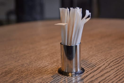 Photo of metal stand with toothpicks on table. Cafe and restaurant. Eating.
