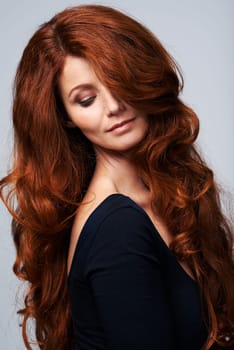 Red head, hair and woman in studio with beauty for keratin treatment, wellness and haircare on white background. Salon, hairdresser and female model with texture shine, healthy and natural hairstyle.