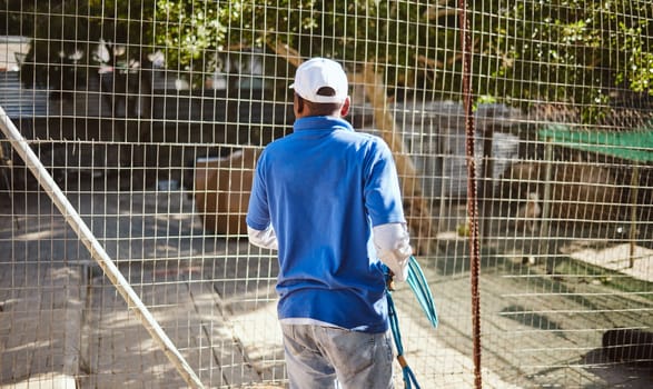 Volunteer, charity and animal shelter with a black man working at a rescue center for the adoption of foster pets. Worker, community and care with a male employee at work alone with rescue animals.