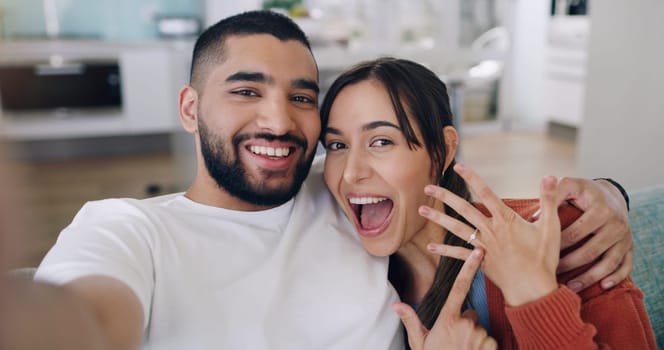 Couple, selfie and engagement ring in home portrait with happiness, romance and love on social media app. Man, woman and profile picture for marriage proposal, offer or celebration with smile on blog.