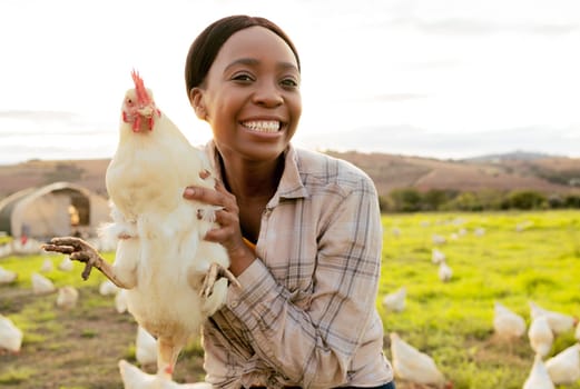 Chicken, farmer and smile in animal farming, agriculture and startup business outdoor in South Africa. Portrait, black woman and happy while working with animals on poultry farm with countryside life.