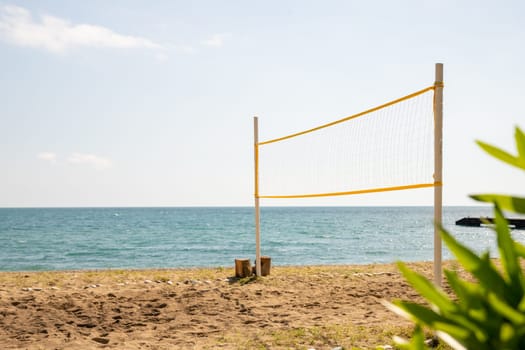 Beach volleyball net on sandy terrain of Halmstad West beach on overcast summer day, selective focus