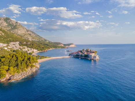 Aerophotography. Aerial view of Sveti Stefan island in a beautiful summer day, Montenegro from flying drone. Panoramic above view of Saint Stephen luxury resort. Tourism and leisure concept.