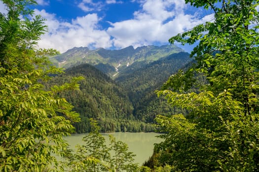 View on the turquoise color lake between high and rocky mountains. Beautiful alpine landscape.