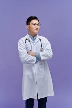 Portrait of confident positive smiling asian male doctor wearing medical white uniform coat and stethoscope