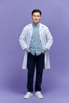 happy young asian man doctor in white uniform with stethoscope smiling isolated in studio