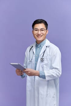 Doctor with tablet on color background