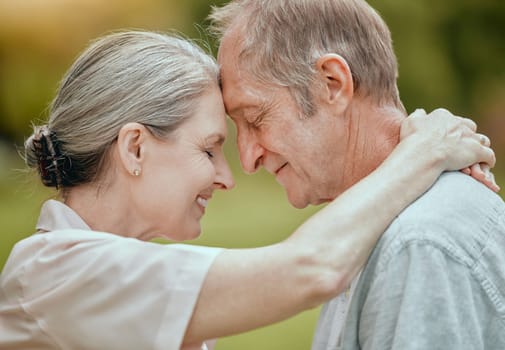 Elderly, couple and forehead touch with love, care and bonding in retirement, outdoor and nature. Senior man, woman and retired romance in park, garden or backyard for hug, happy or face together.
