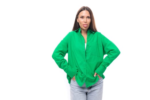 pretty slim european brunette woman with long hair and brown eyes dressed in casual green shirt showing tongue.