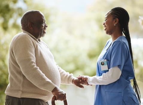Senior man, caregiver and holding hands for support, healthcare and happiness at retirement home. Elderly patient and black woman or nurse together for trust, hope and help for health and wellness.