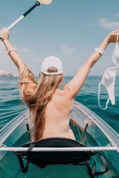 Woman in kayak back view. Happy young woman with long hair floating in transparent kayak on the crystal clear sea. Summer holiday vacation and cheerful female people having fun on the boat.