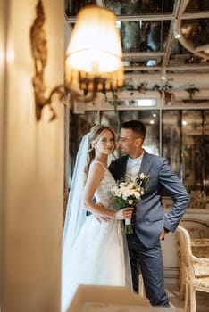 bride and groom inside a cocktail bar in a bright atmosphere with a glass of drink