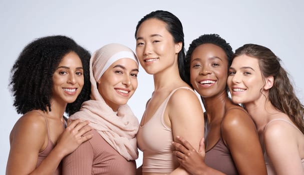 Diversity, woman and beauty portrait for body positive support, happiness and skincare wellness. Interracial models, happiness solidarity and smile for skin glow, cosmetics dermatology in studio.
