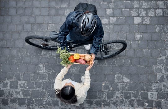 Grocery customer, courier delivery and biker with retail sales product, shopping nutritionist or food shipping container. Logistics supply chain, top view and cycling distribution person with bicycle.