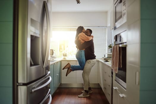 Black couple, happy home and love while together with care and happiness in a marriage with commitment and care. Young man and woman hug while in the kitchen to celebrate their house or apartment.