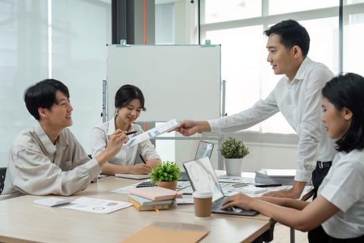 Business team people discussing analyzing investment charts the charts and graphs showing the results of their successful teamwork, typing keyboard, analyze graph plans.