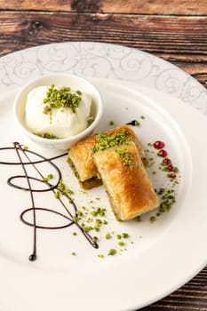 Traditional Turkish dessert pistachio baklava on a white porcelain plate
