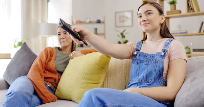 Relax conversation and girl friends on a living room sofa at home talking in the lounge. House couch, young people and happy communication with a smile and hot drink speaking and listening.